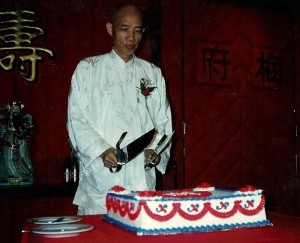 Moy Yat Posing over his Birthday Cake